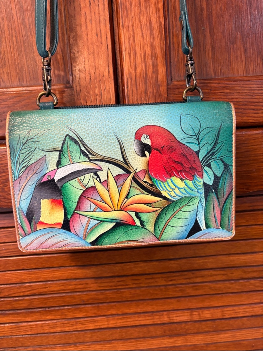 Anuschka Teal Crossbody with Red Parrot and Multicolor Tropical Print